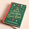 So This Is Christmas Quiz Book against beige background