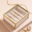 Personalised Name Mini Glass Jewellery Box in Gold against beige surface 