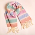 Pastel Stripe Cream Winter Scarf on a Beige Background