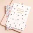 A charming birthday card with a repeating bee pattern