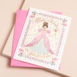 A birthday card with a princess on the front covered in gold, sparkly accents