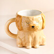 Sass & Belle Cockapoo Shaped Mug Against a Beige Background