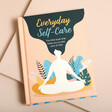 A book for self care, relaxation and mindfulness with a meditating girl on the cover