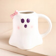 A traditional ghost shaped mug with a 3d pink bow and a blushing, spooky face.