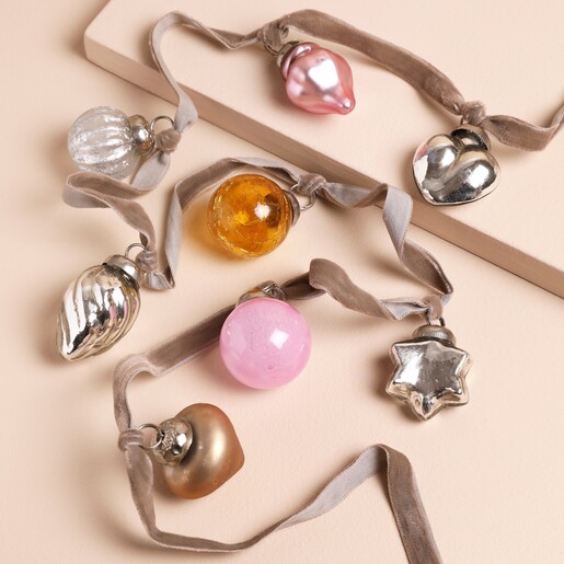 Mixed Mini Bauble Ribbon Garland with pink, silver, gold and orange baubles on a beige background