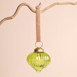 Ribbed Green Glass Sultan Bauble on a beige background