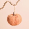 Small Felted Orange Pumpkin Ornament Hanging From a Tree Branch