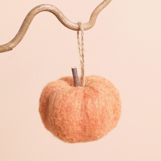 Small Felted Orange Pumpkin Ornament Hanging From a Tree Branch