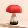 Large Red Mushroom Standing Decoration on a Beige Background