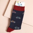 A pair of mens navy blue socks with a small repeating bike pattern on it