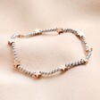 Silver Stainless Steel & Rose Gold Star Beaded Bracelet on Beige Background