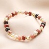 Autumn Coloured Mixed Beaded Bracelet in Gold on Beige Fabric