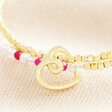 Close up of the doodle heart charm and dual layer of beads in gold, pink and clear