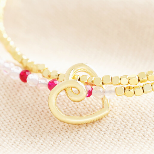 Close up of the doodle heart charm and dual layer of beads in gold, pink and clear