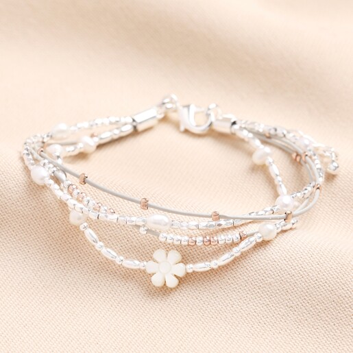 Silver and Rose Gold Daisy Multi Strand Bracelet on a neutral background