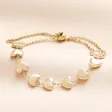 A delicate trace chain bracelet with sideways heart charms and a pulley adjusting system. 