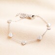 A dainty heart charm bracelet with silver stainless steel hearts seperated by a trace chain and lobster fastening.