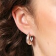 Model Shot of Stainless Steel Tapered Huggie Hoop Earrings