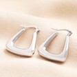 Both Stainless Steel Angular Hoops Laying Flat on a Neutral Fabric