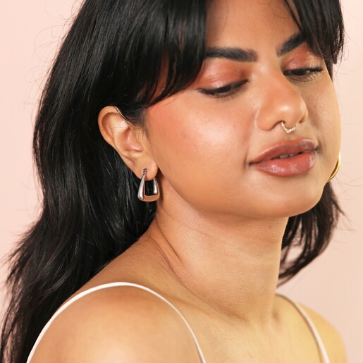 Model Wearing Earrings Dark Haired Model Wearing Stainless Steel Triangular Chunky Hoop Earring in Her Lobe