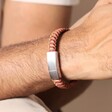 Close Up of Personalised Men's Stainless Steel Thick Braided Leather Bracelet in Brown on Model