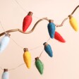 A garland of colourful retro light bulbs made from felted wool