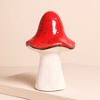 A medium-sized toadstool decoration with a wide standing base and a red textured cap