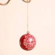 Red Geometric Floral Bauble on a Beige Background