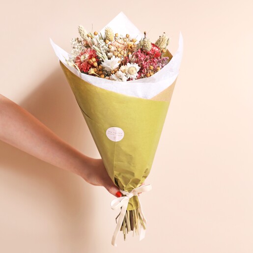 Fall Floral Dried Flower Bouquet wrapped in green paper being held