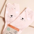 A pair of light pink Trixie bunny socks with cheerful face detail and floppy ear style details