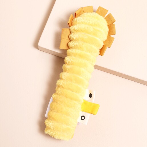 Back of yellow Trixie Lion Baby Squeaker Toy with corduroy back and soft cotton. Displayed on a beige background.