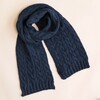 Navy Cable Knit Winter Scarf on a Beige Background