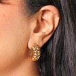 Close Up of Model Wearing Chunky Twisted Rope Half Hoop Earrings in Gold