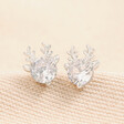 Festive Crystal Reindeer Stud Earrings in Silver on Beige Fabric