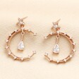 Close up of Crystal Moon and Teardrop Drop Earrings in Rose Gold