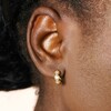Close Up of Model Wearing Small Round Crystal Huggie Hoop Earrings in Gold