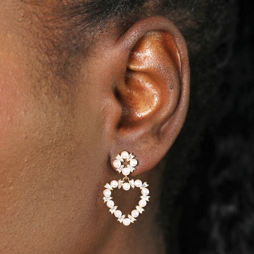 Close Up of Earrings on Model Close Up of Model Wearing Pearl and Crystal Heart Drop Earrings in Gold