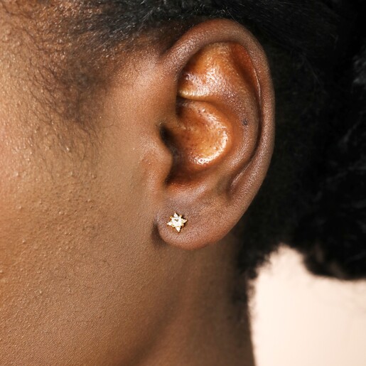 Close Up of Earrings on Model Close Up of Tiny Crystal Star Stud Earrings in Gold on Model