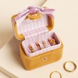 Opened Mustard and Pink Velvet Bow Travel Ring Box on a neutral background