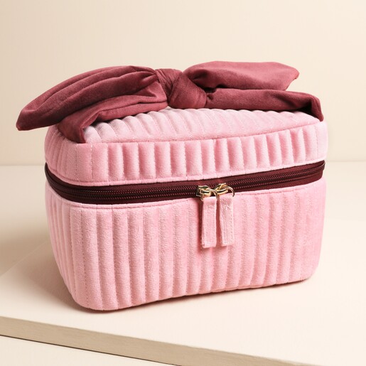 Pink and burgundy washbag on a neutral background