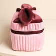 Pink and burgundy washbag on a neutral background