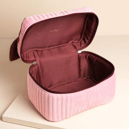 Pink and burgundy washbag on a neutral background with open zipper