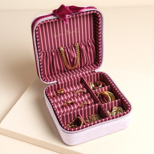 Open jewellery box with lilac fabric and pink interior