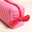 Side of washbag with red bow detail