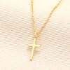 Sterling Silver Cross Necklace in Gold on a neutral background
