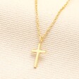 Sterling Silver Cross Necklace in Gold on a neutral background