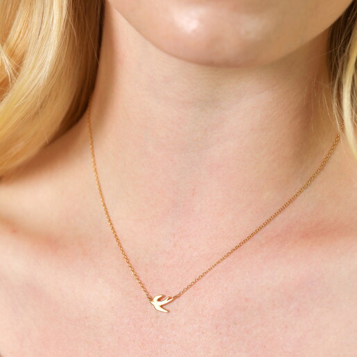 Close up of Flying Bird Pendant Necklace in Gold