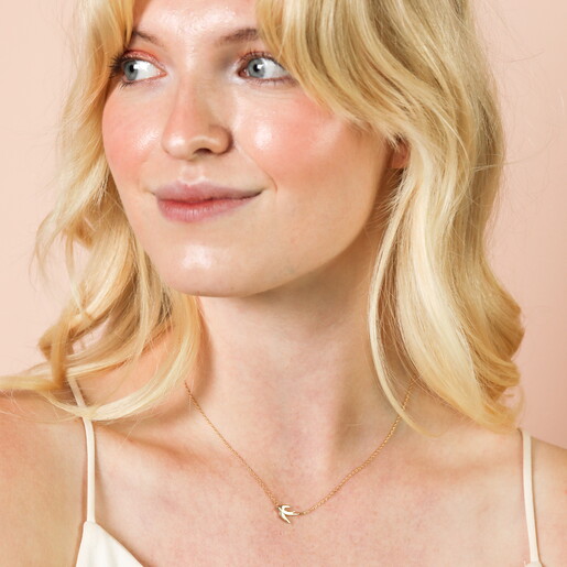 Close up of Flying Bird Pendant Necklace in Gold