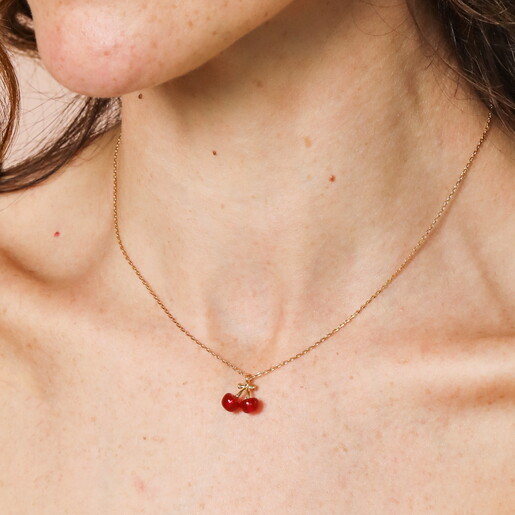 Beaded Cherry Pendant Necklace in Gold on a neutral background