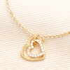 Close Up of Sterling Silver Interlocking Crystal Heart Charm Bracelet in Gold